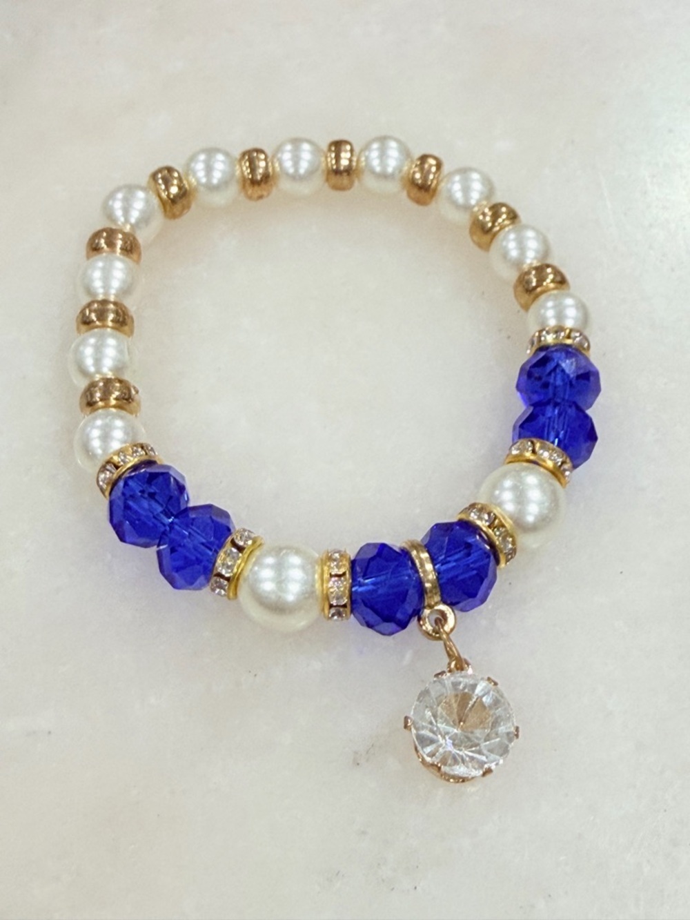 Gold and Pearl Beaded Stretch Bracelet with Blue Crystal Accents and Charm